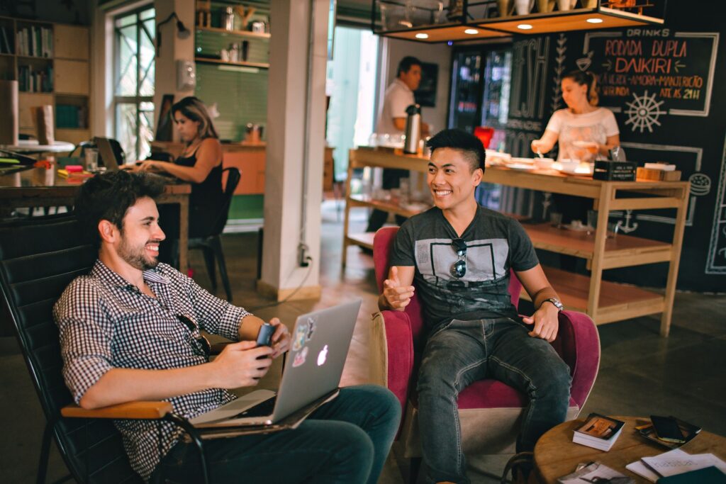 featured image for starting a dog grooming businessfeaturing two men laughing white sitting on chairs