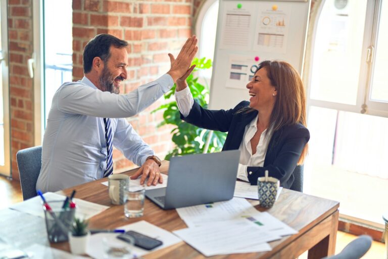 featured image for client retention featuring man in white dress shirt sitting beside woman in black long sleeve shirt